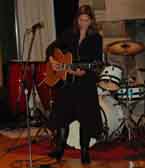 Photo of Carrie playing guitar at SAI.