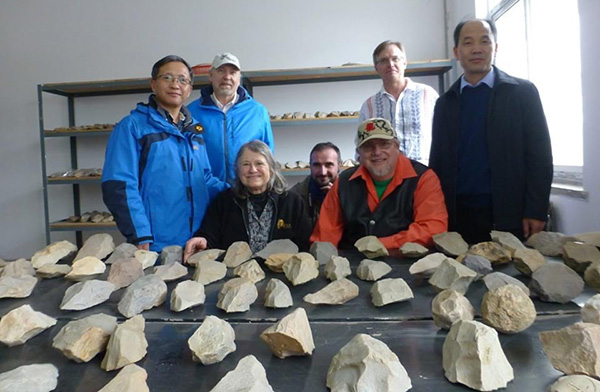 Research group examining artifact collections during the workshop