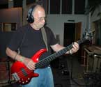 Photo of Henry Corning playing bass guitar.