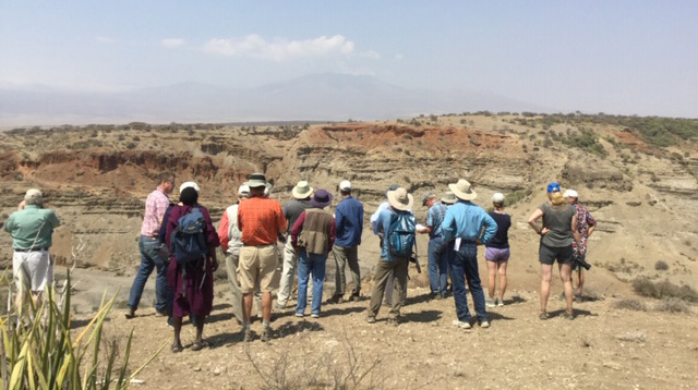 Research group look out over Olduvai Gorge near the Second Fault, visible in the beckground.